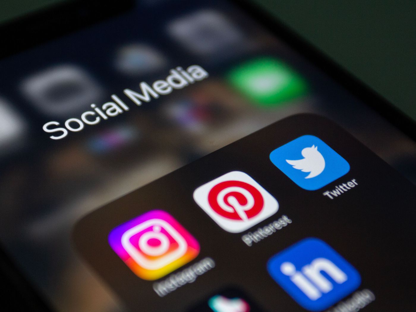 Instagram, Pinterest, Twitter and LinkedIn apps in a Social Media folder on a phone