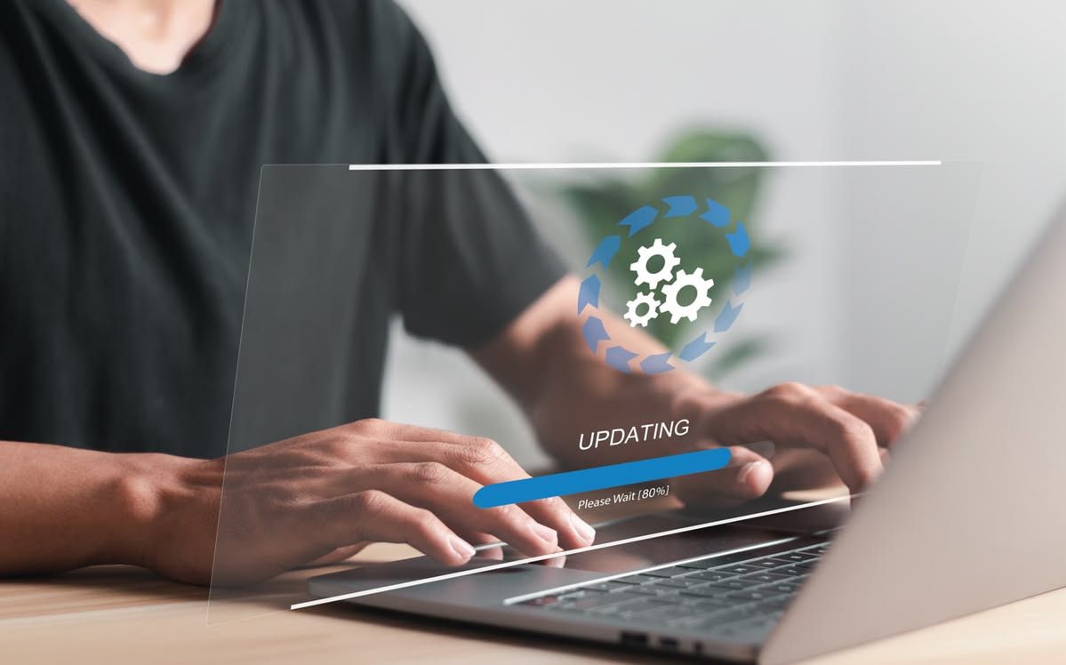 Website software update in progress on a laptop during routine website maintenance